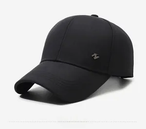 Detail view of the black baseball cap showing cotton twill texture and metal logo
