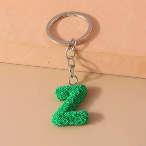 Detailed macro view of letter Z keychain with green rose texture and silver link chain