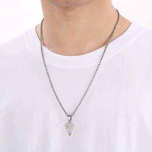 Close-up of silver stainless steel twist chain and half-heart pendant on a model
