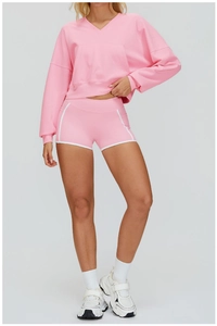 Detail of pink hooded sweatshirt with V-neckline and functional kangaroo front pocket