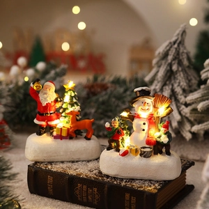 Luminous Christmas resin ornaments featuring Santa and Snowman on vintage books