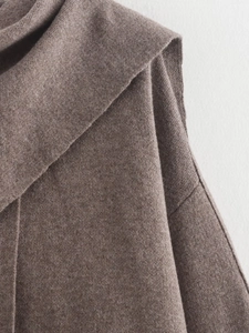 Close-up of the soft knitted texture and collar detail of this brown wool coat