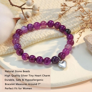 Detail showing natural stone bead bracelet with a high quality silver heart charm