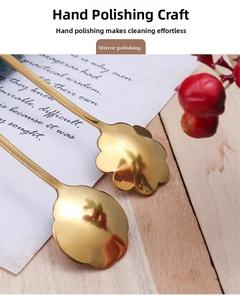 Detail view of gold floral-shaped stainless steel spoon with polished mirror finish