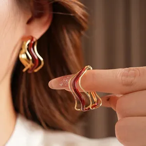 Golden wavy hoop earrings with deep red enamel drip, minimalist fashion jewelry for women