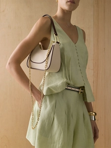Light green cotton linen vest and high waist pleated shorts set with beige shoulder bag