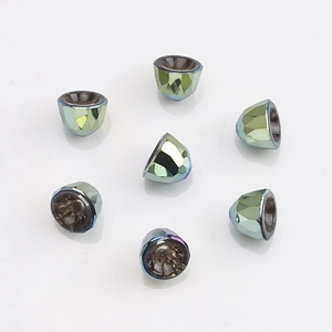 Macro detail of 8mm faceted glass crystal bell pendants with iridescent blue-green coating