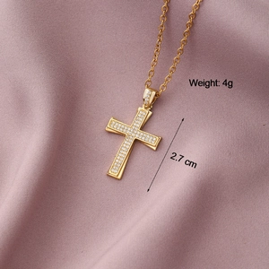Macro shot of gold cross pendant with cubic zirconia, height 2.7cm and weight 4g