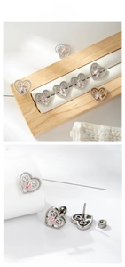 Detailed view of pink butterfly heart stud with secure screw-back titanium steel post