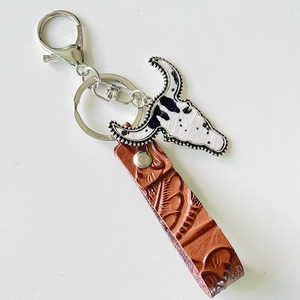 Close-up of Western style leather keychain featuring a vintage bull head pendant and texture