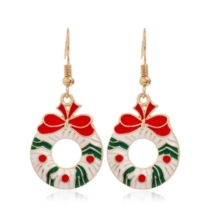 Detailed view of Christmas wreath earrings with red bow and festive green leaves