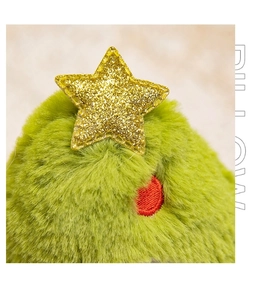 Macro shot of green plush Christmas tree texture with a gold sequin star detail