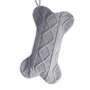 Gray knitted bone shaped Christmas stocking with woven diamond pattern for holiday decor