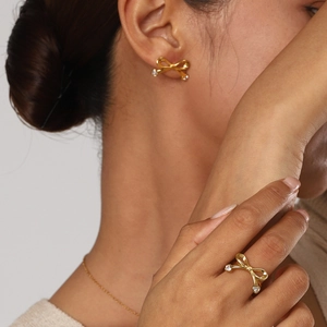 Close-up of 18k gold plated bow and heart jewelry set with sparkling zircon stones