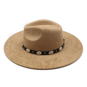 Detail of khaki wide brim fedora hat featuring a black leather band with silver studs