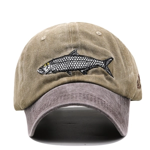 Detailed embroidery of a shark on a khaki and dark grey washed cotton baseball cap