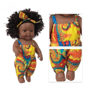 Close-up of African American baby doll showing vibrant tie-dye fabric and foot details