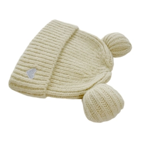 Close-up of beige cable knit beanie featuring sequined heart and cute plush bear ears