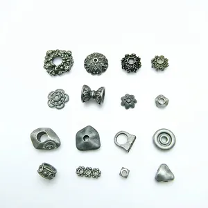 Collection of vintage silver-tone alloy bead spacers in various floral and geometric styles