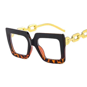 Modern oversized square glasses with black tortoise frame and gold chain temples