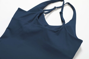 Close-up of adjustable thin straps with silver metal buckles on a navy yoga tank top