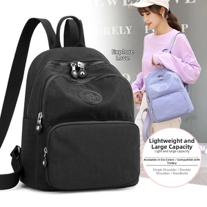 Water-resistant nylon travel backpack for women with luggage strap and dual zip pockets