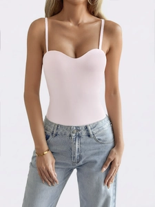Detailed view of a stylish pink Y2K tube top bodysuit paired with light blue jeans