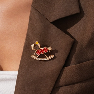 Detailed close-up of a cartoon horse brooch with colorful enamel and sparkling zircons