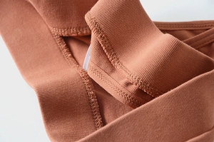 Close-up of brown cotton ribbed texture and high-quality stitching on the thong underwear