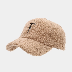 Close-up of beige faux lamb wool baseball cap with black Faith embroidery detail