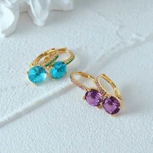 Close-up of gold plated 925 sterling silver hoop earrings with blue and purple crystals