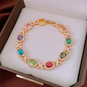 Bracciale vintage dorato con gemme ovali multicolore e dettagli a forma di X brillanti