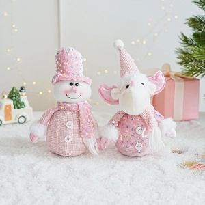 Pink Christmas sequin plush snowman and reindeer figurines sitting in festive snow decor
