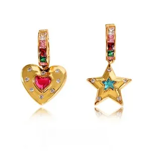 Detail of asymmetric gold heart and star earrings with colorful zircon inlay
