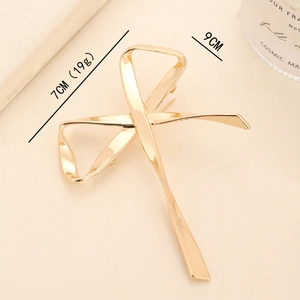 Elegant gold metal bow brooch pin with high-polish finish, minimalist ribbon style 9cm long
