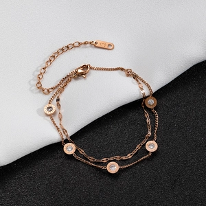 Detailed macro of rose gold double-layer chain with Roman numeral pendant and K18 hallmark