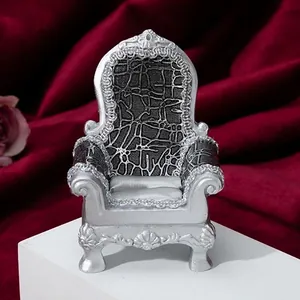 Silver vintage miniature armchair jewelry display for rings and earrings on red velvet