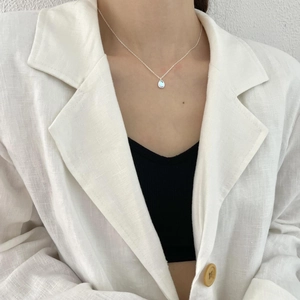Minimalist 925 sterling silver necklace featuring a teardrop opal pendant on a female model