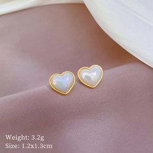 Minimalist titanium steel heart stud earrings with iridescent pearl finish on satin