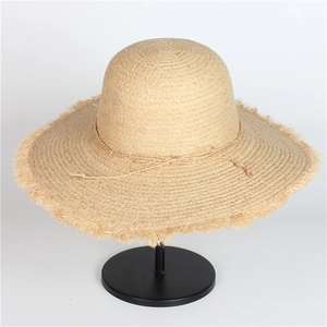 Handmade wide brim raffia straw sun hat with frayed edges and bow for beach vacation