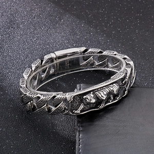 Detail of 316L stainless steel bracelet with tiger relief and Greek key patterns