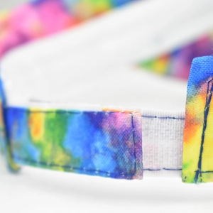 Macro shot of rainbow fabric sun hat detail featuring secure white hook and loop fastener