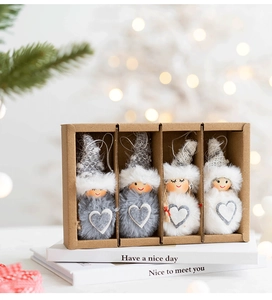 Detailed view of four gnome Christmas ornaments in a gift box with festive background