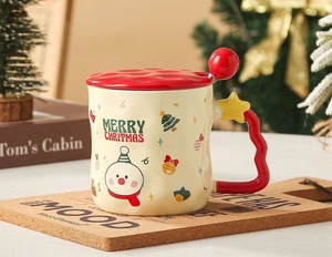 Close-up of Christmas ceramic mug with snowman pattern, red wave handle and star detail