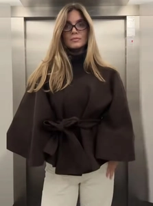 Detail of dark brown wool wrap coat featuring a chic stand collar and adjustable waist belt