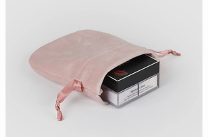 Close-up of pink velvet gourd pouch with matching ribbon drawstring for jewelry storage