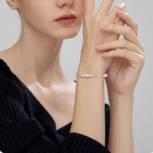 Close-up of elegant natural freshwater pearls on a delicate silver chain bracelet for women