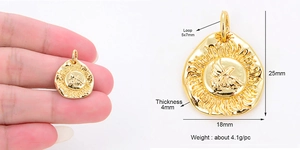 Macro detail of a 25mm gold sun and bird pendant with exact size and weight dimensions