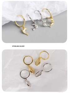 Detail of s925 sterling silver ocean shell and dolphin earrings in gold and silver