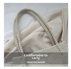 Detailed macro view of cream woven tote bag showing thick handles and knit texture